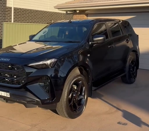 A finished dark Isuzu with glossy paint and tinted glass