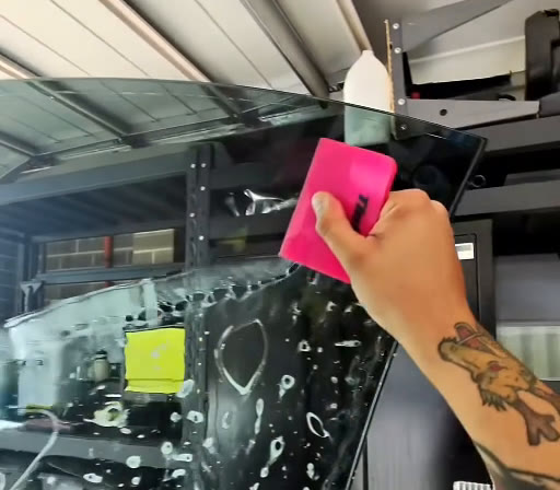 Tyler smoothing ceramic window film with a pink squeegee